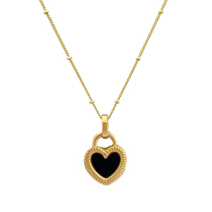 Close-up of gold heart pendant with black shell inlay and textured edge on satellite chain