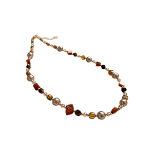 Tiger eye geometric beaded necklace with brown stones and pearls on white background