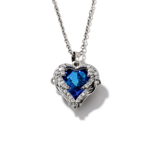 Blue heart zircon pendant necklace with crystal wing design and delicate silver chain