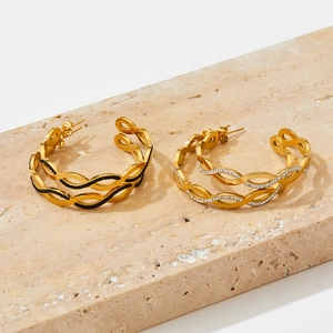 Elegant gold twisted C-shaped earrings with diamond accents and black enamel details