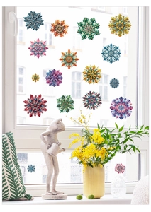 Detailed close-up of colorful crystal snowflake window stickers on a bright glass pane