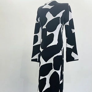 Detail of knit midi dress featuring abstract black and white print and slim-fit back design