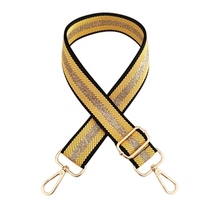 Close-up of adjustable woven purse strap with gold metallic thread and lobster clasps