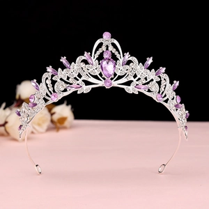 Macro shot of a Baroque crown with purple teardrop gemstone and silver filigree