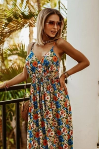 Outdoor shot of a tropical V-neck floral maxi dress with vibrant orange and blue patterns