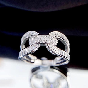 Elegant silver interlocking U-shaped ring with brilliant cubic zirconia on black background