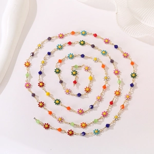 Macro spiral view of colorful daisy flower charms and gold chain necklace link details