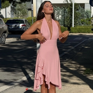 Detailed view of the halter neck deep V-neckline and waist cut of the pink summer dress