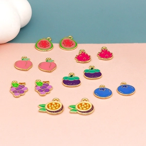 Detailed macro view of mixed fruit alloy charms with gold borders for DIY jewelry making