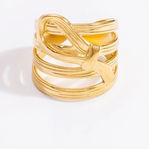 Detailed view of the layered interlaced gold hollow bow ring with smooth metal luster
