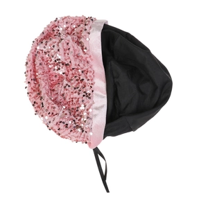 Detailed shot of pink sequined velvet beret with satin trim and black tie ribbons