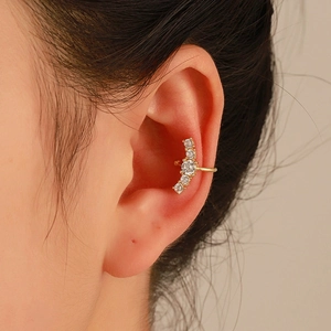 Detailed view of a gold-plated multi-layer ear cuff featuring five sparkling white zircons