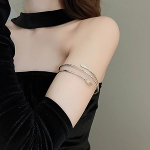 Detailed macro view of silver multi-layer spiral arm cuff with hand-hammered textures