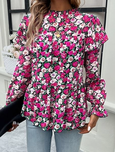 Close-up of floral blouse showing high neck with ruffle trim and peplum waist detail