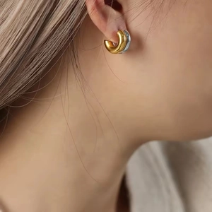 Polished C-shape chunky hoop earrings in gold and silver finish for a minimalist look