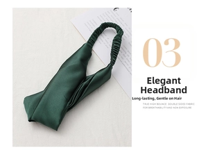 Detail of forest green satin headband featuring a wide knot design and elastic back band