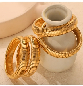 Detailed macro view of 18K gold-plated textured snake chain elastic cuff bracelets