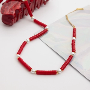 Close-up of red turquoise beads and white pearls on 18K gold stainless steel necklace