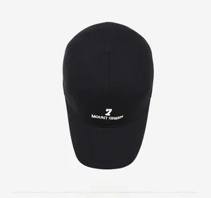 Detailed view of black cotton baseball cap featuring white 7 MOUNT GREEN letter embroidery