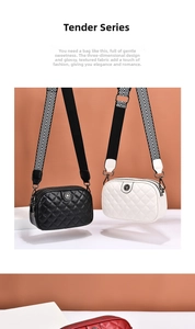 Detail of quilted crossbody bag with wide chevron strap and embossed metal ornament