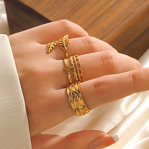 Set of 4 gold vintage adjustable open rings featuring leaf, star and Celtic wave patterns