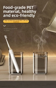 Detail of dark gray translucent PET toothbrush holders on a premium marble surface