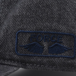 Close-up of the high-quality FORCE embroidery detail on washed gray denim baseball cap