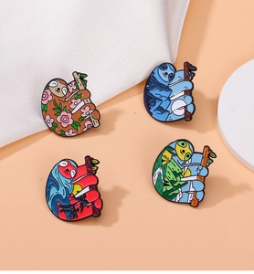 Detail view of four colorful sloth enamel pins with artistic landscape patterns