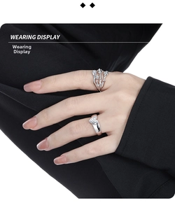 Detail shot of heart-shaped gem and tulip floral ring on hand for elegant styling