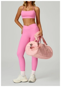 Pink high-waist yoga set featuring cross waist leggings with pockets and a matching sports bag