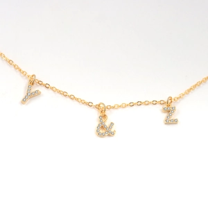 Gold pendant necklace with micro-pave zircon letters Y and Z and ampersand charm