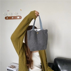 Detail view of the chevron pattern wool handbag with a sturdy magnetic snap closure