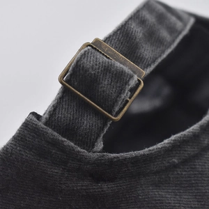 Detail of adjustable metal buckle and washed cotton texture on the back of baseball cap