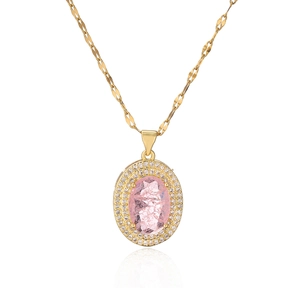 Gold plated oval necklace with pink gemstone and zircon halo on white background