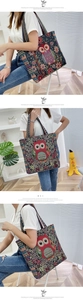 Detail of colorful owl pattern on a large canvas tote bag with ethnic woven handles