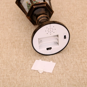 Detailed base of vintage Christmas lantern showing battery compartment and on-off switch