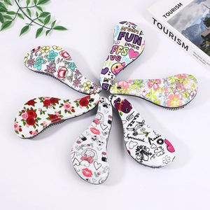 Set of colorful paddle hair brushes with floral patterns and ergonomic handles