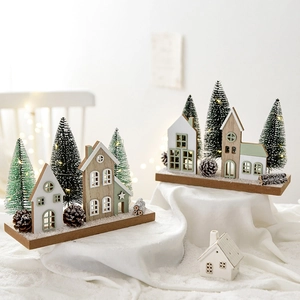 Lighted wooden Christmas house decoration with LED lights and artificial snow landscape