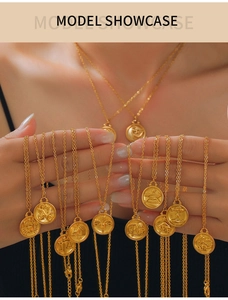 Detail of 18K gold zodiac coin necklaces with embossed star and celestial patterns