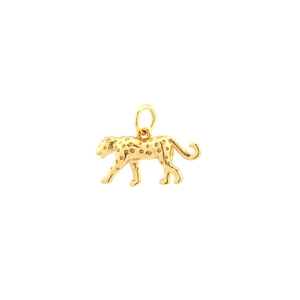 Macro shot of golden leopard pendant with textured spots and a circular connector loop