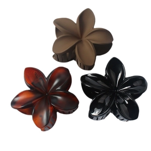Three-piece flower hair claws in matte coffee, amber texture, and glossy black finish