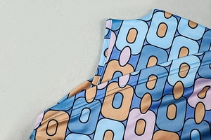 Macro shot of vintage geometric print on glossy satin fabric with neat stitching