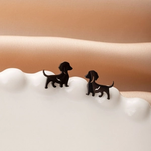 Cute black dachshund dog stud earrings in matte finish for women on white ceramic tray