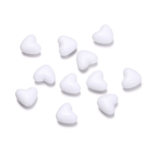 Top-down view of eleven solid white heart-shaped acrylic beads for DIY jewelry making