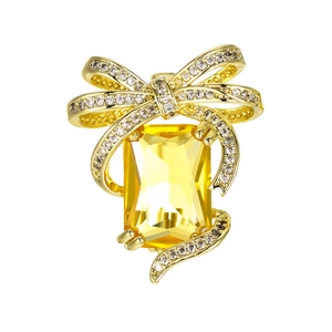 Broche nœud dorée exquise avec une grande pierre jaune et des cristaux scintillants