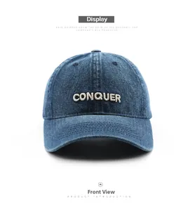 Detailed front view of navy blue denim baseball cap with white Conquer embroidery