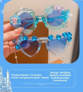 Detail of handmade Frozen series sunglasses with Elsa motifs and blue heart gemstones