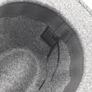Detail view of the hat interior showing material tag with wool and polyester composition