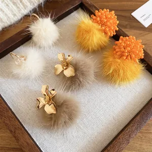 Chic floral pompom drop earrings in cream, beige and orange for autumn and winter styles