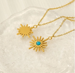 Close-up of gold stainless steel necklace featuring a turquoise sunburst star pendant